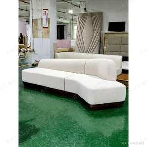 Understated Curved Sofa in oatmeal — in a room setting