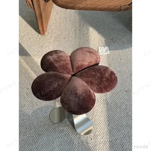 Petal Upholstered Stool on Curved Stainless-Steel Base in rose stone — in a room setting