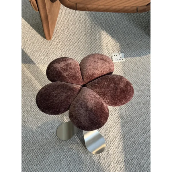 Petal Upholstered Stool on Curved Stainless-Steel Base in rose stone — in a room setting