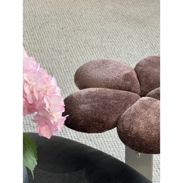 Petal Upholstered Stool on Curved Stainless-Steel Base in rose stone — in a room setting