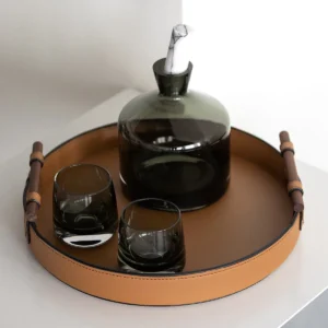 Round Tan Leather Tray in clay — in a room setting