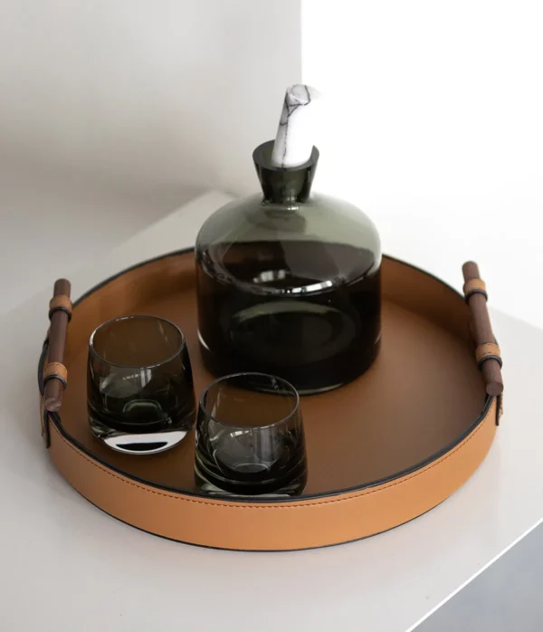 Round Tan Leather Tray in clay — in a room setting