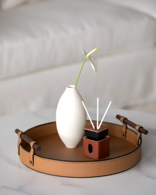 Round Tan Leather Tray in clay — in a room setting