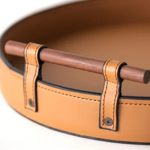 Round Tan Leather Tray in clay — in a room setting