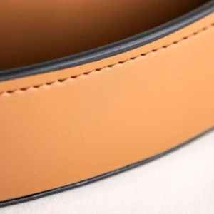 Round Tan Leather Tray in clay — in a room setting
