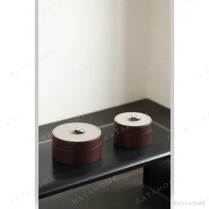 Vintage Brown Leather Round Storage Box with Grey Lid in clay — in a room setting