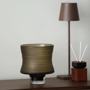Brown Ribbed Frosted Glass Vase on Dark Foot, Short or Tall in clay — in a room setting