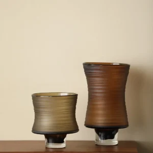 Brown Ribbed Frosted Glass Vase on Dark Foot, Short or Tall in clay — in a room setting
