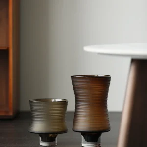 Brown Ribbed Frosted Glass Vase on Dark Foot, Short or Tall in clay — in a room setting