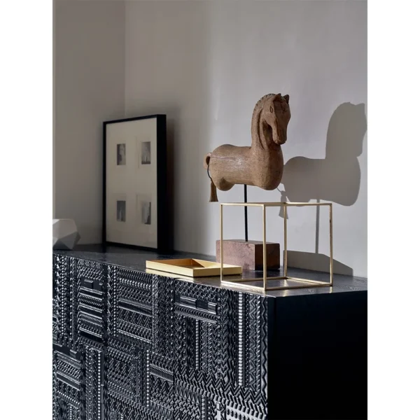 Carved Geometric Sideboard in Black on Steel Base — in a room setting