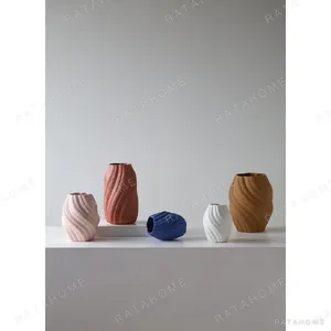 Matte Twisted Rib Ceramic Vase, Three Sizes in sand — in a room setting