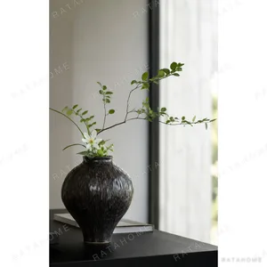 Dark Brown Hammered Narrow-Neck Ceramic Vase in clay — in a room setting