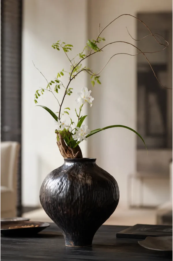 Dark Brown Hammered Narrow-Neck Ceramic Vase in clay — in a room setting