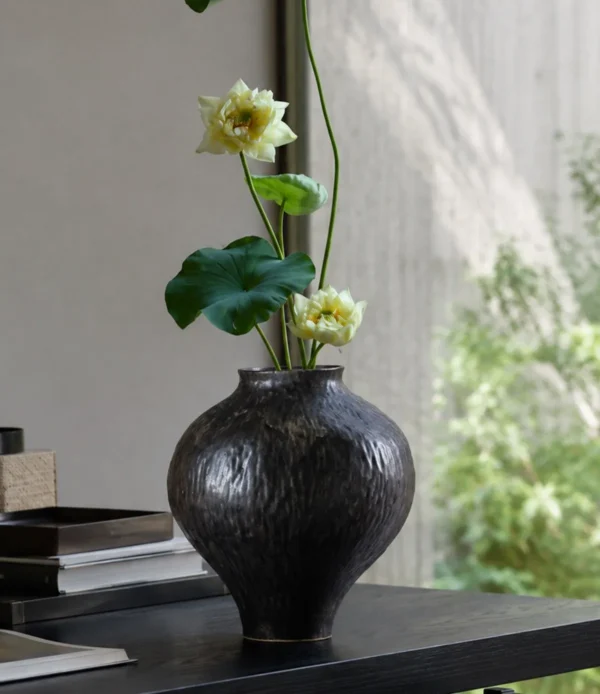 Dark Brown Hammered Narrow-Neck Ceramic Vase in clay — in a room setting