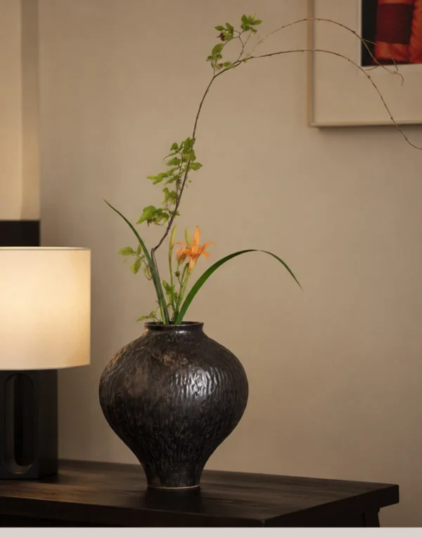 Dark Brown Hammered Narrow-Neck Ceramic Vase in clay — in a room setting