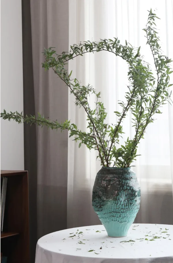 Deep Sea Blue Gradient Pleated Ceramic Vase in blue — in a room setting