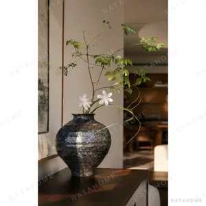 Kiln-Change Mottled Blue-Black Round Jar Vase, Small in black — in a room setting