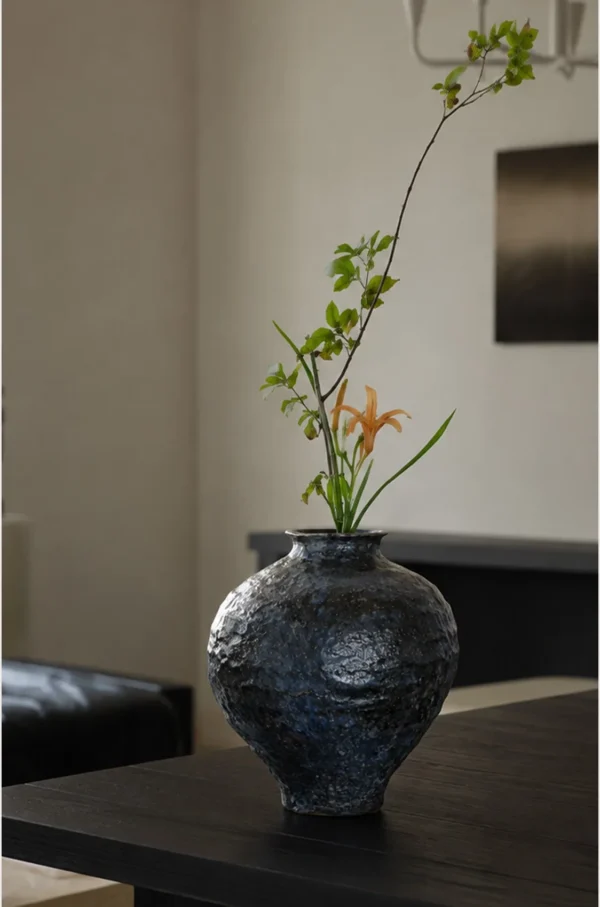 Kiln-Change Mottled Blue-Black Round Jar Vase, Small in black — in a room setting