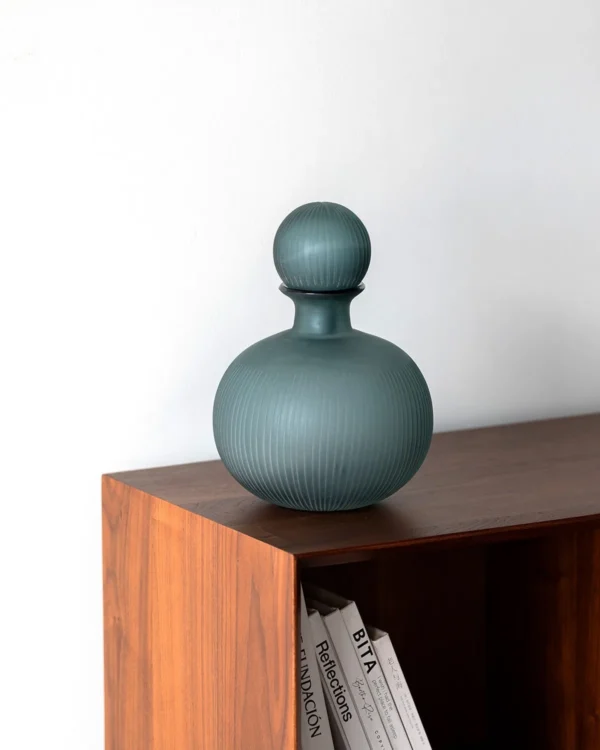 Mist Blue Ribbed Frosted Glass Bottle Vase with Ball Stopper in blue — in a room setting