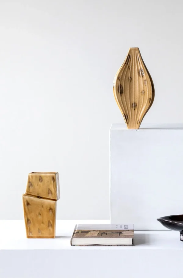 Ochre Ribbed Diamond Ceramic Vase on Flared Foot, Two Forms in mustard — in a room setting