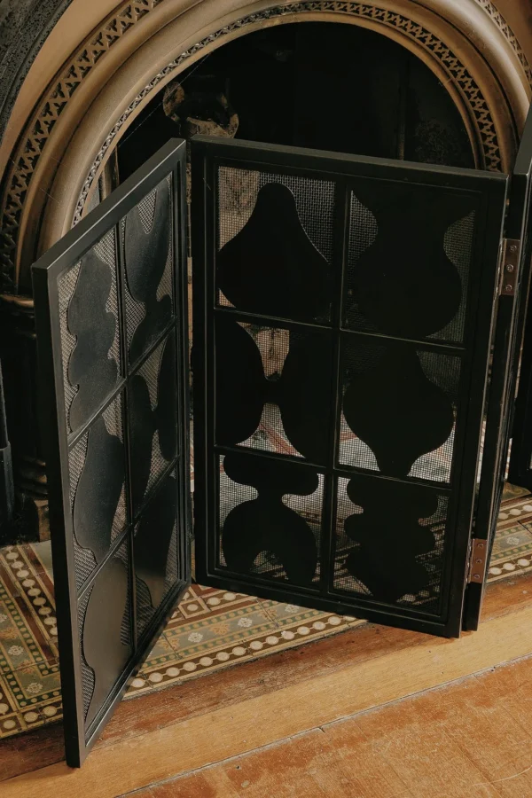 Vessel-Silhouette Openwork Folding Screen in black — in a room setting