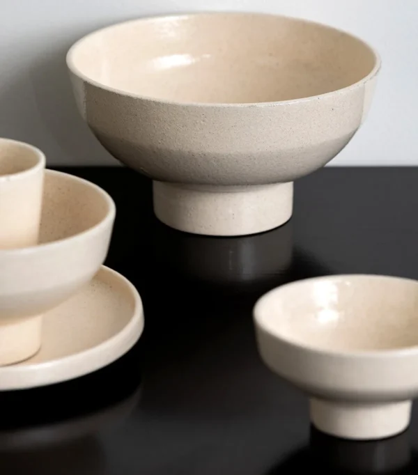 Sand-Cream Stoneware Footed Bowls in oatmeal — in a room setting