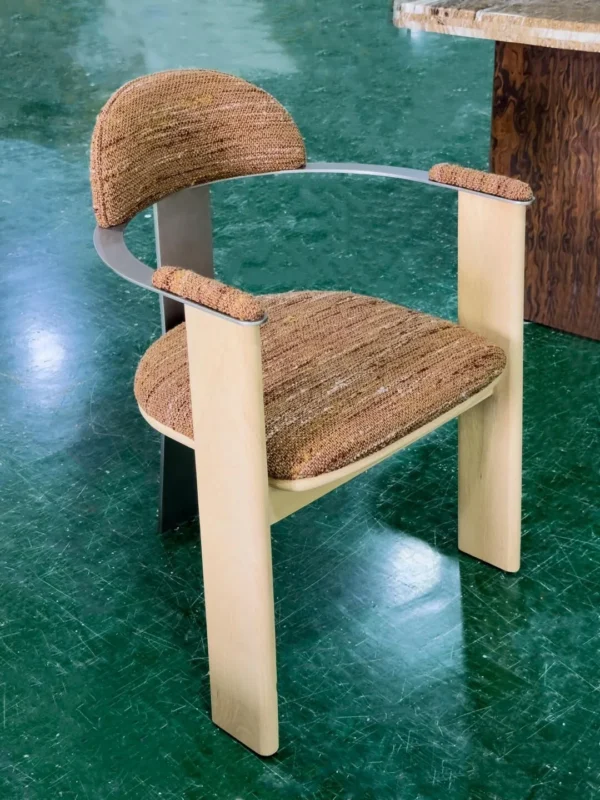 Light Wood Armchair with Curved Metal Back in Mixed Weave — in a room setting