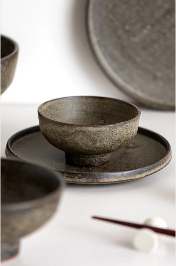 Vintage Textured Stoneware Footed Bowls and Plates in clay — in a room setting