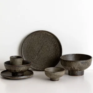 Vintage Textured Stoneware Footed Bowls and Plates in clay — in a room setting