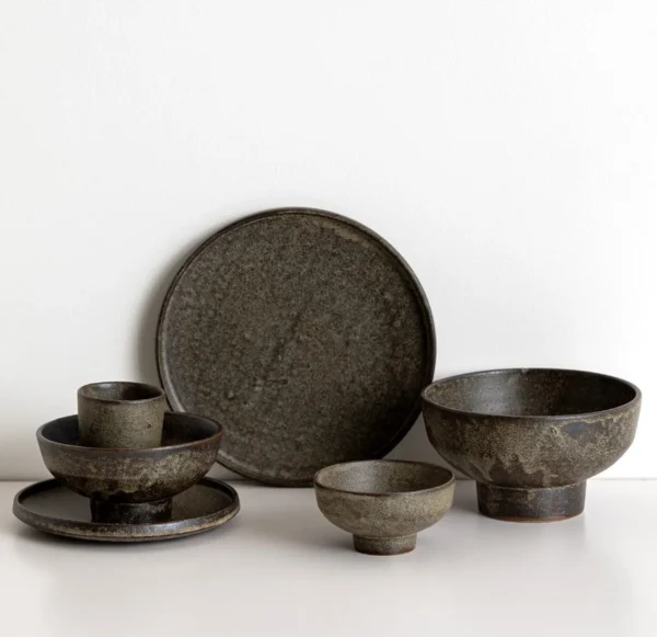 Vintage Textured Stoneware Footed Bowls and Plates in clay — in a room setting