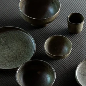 Vintage Textured Stoneware Footed Bowls and Plates in clay — in a room setting
