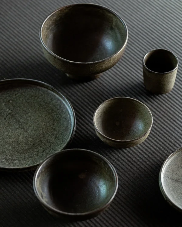 Vintage Textured Stoneware Footed Bowls and Plates in clay — in a room setting