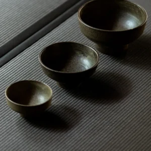 Vintage Textured Stoneware Footed Bowls and Plates in clay — in a room setting