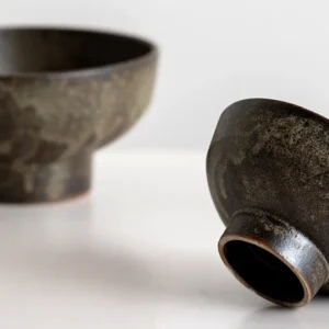 Vintage Textured Stoneware Footed Bowls and Plates in clay — in a room setting
