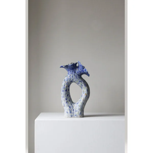 Blue Pierced Sculptural Ceramic Vase with Flared Mouth in blue — in a room setting