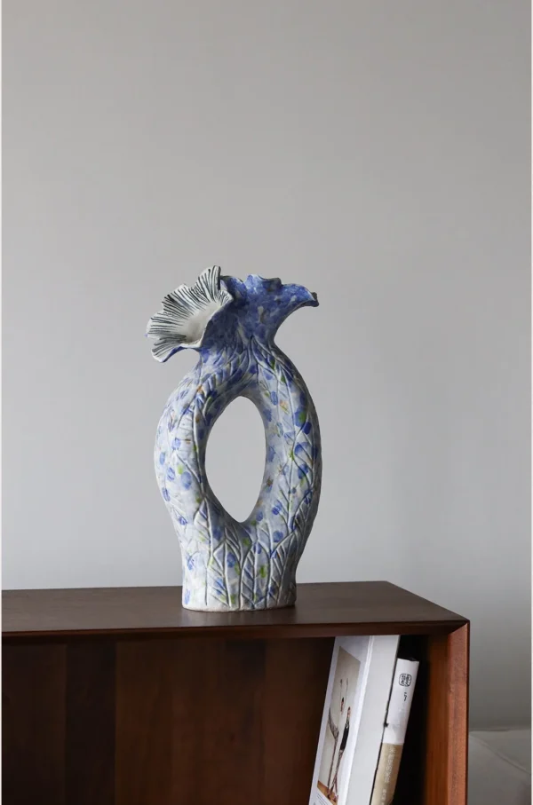 Blue Pierced Sculptural Ceramic Vase with Flared Mouth in blue — in a room setting