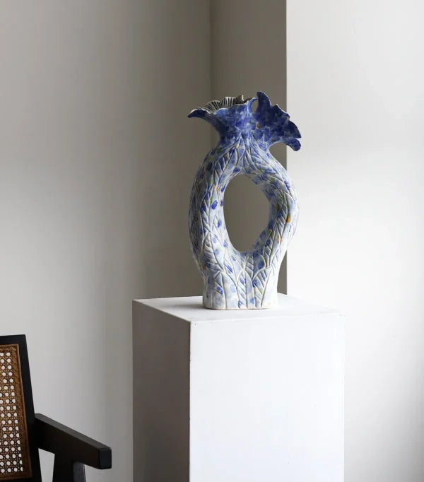 Blue Pierced Sculptural Ceramic Vase with Flared Mouth in blue — in a room setting