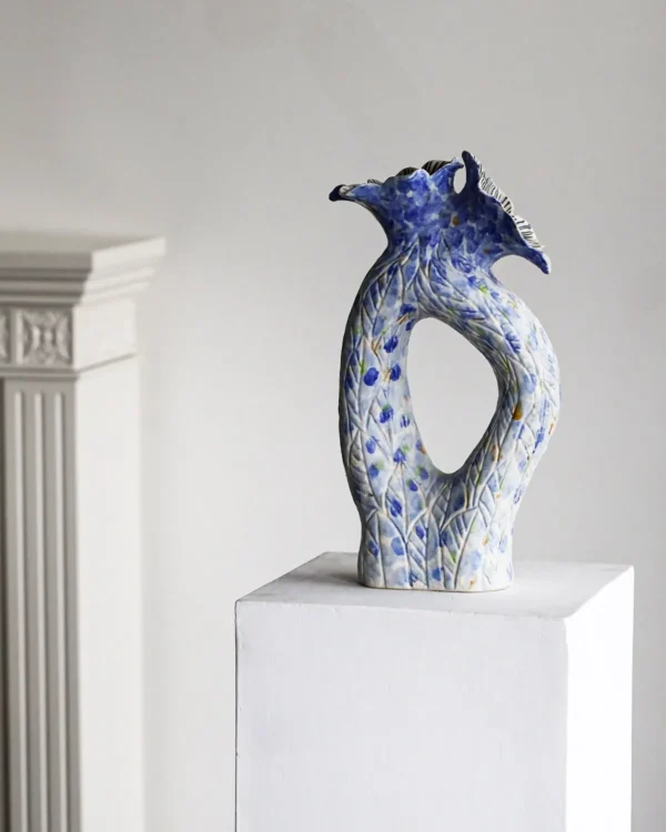 Blue Pierced Sculptural Ceramic Vase with Flared Mouth in blue — in a room setting