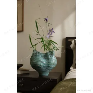 Wabi-Sabi Green Rock Texture Ceramic Vase with Torn Rim in olive — in a room setting