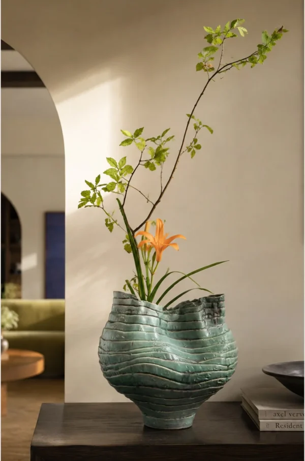 Wabi-Sabi Green Rock Texture Ceramic Vase with Torn Rim in olive — in a room setting