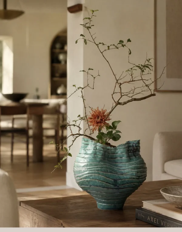Wabi-Sabi Green Rock Texture Ceramic Vase with Torn Rim in olive — in a room setting