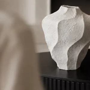 Designer Wabi-Sabi Folded Texture Ceramic Vase, Short in ivory — in a room setting
