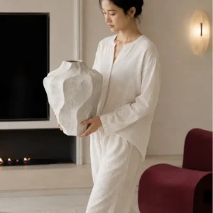 Designer Wabi-Sabi Folded Texture Ceramic Vase, Short in ivory — in a room setting
