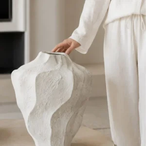 Designer Wabi-Sabi Folded Texture Ceramic Vase, Short in ivory — in a room setting