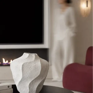 Designer Wabi-Sabi Folded Texture Ceramic Vase, Short in ivory — in a room setting