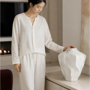 Designer Wabi-Sabi Folded Texture Ceramic Vase, Short in ivory — in a room setting