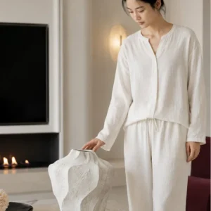 Designer Wabi-Sabi Folded Texture Ceramic Vase, Short in ivory — in a room setting