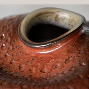 Wabi-Sabi Kiln-Change Flat-Belly Ceramic Vase, Green, Red in olive — in a room setting
