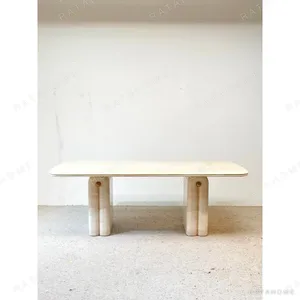 Wabi-Sabi Travertine Dining Table with Arched Legs in oatmeal — in a room setting