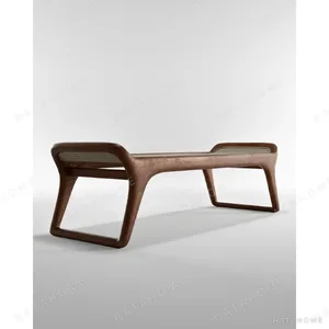 Black Walnut Bench with Woven Rattan Seat and Sculpted Legs in walnut — in a room setting